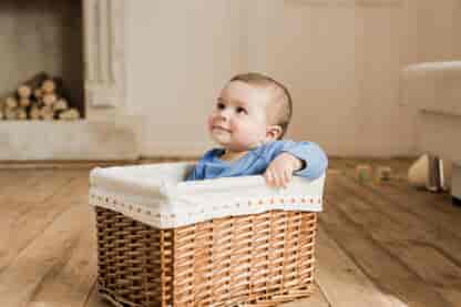 Baby boy sitting in the basket